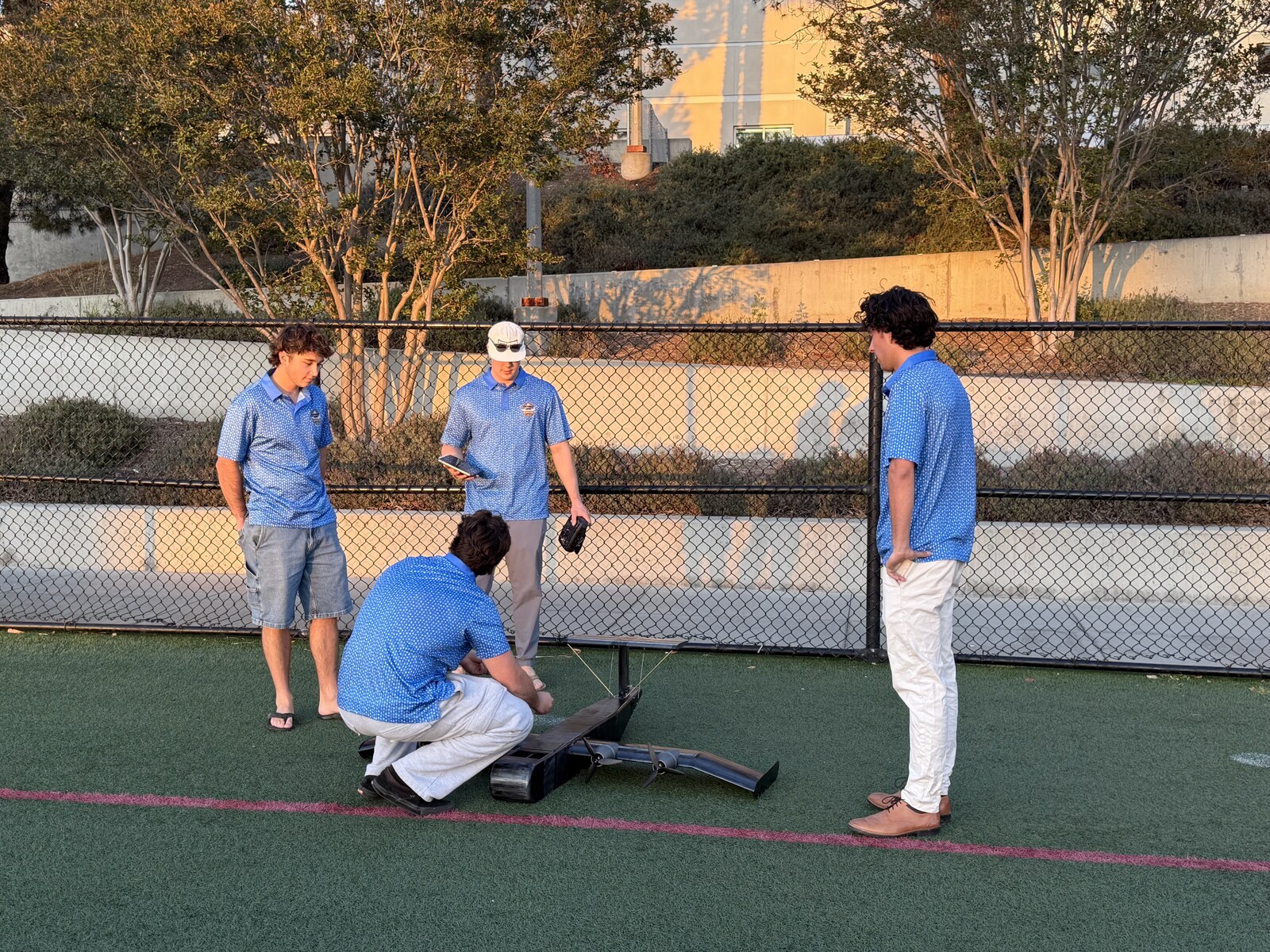 Team performing a pre-flight check on the WIG vehicle on the practice field.